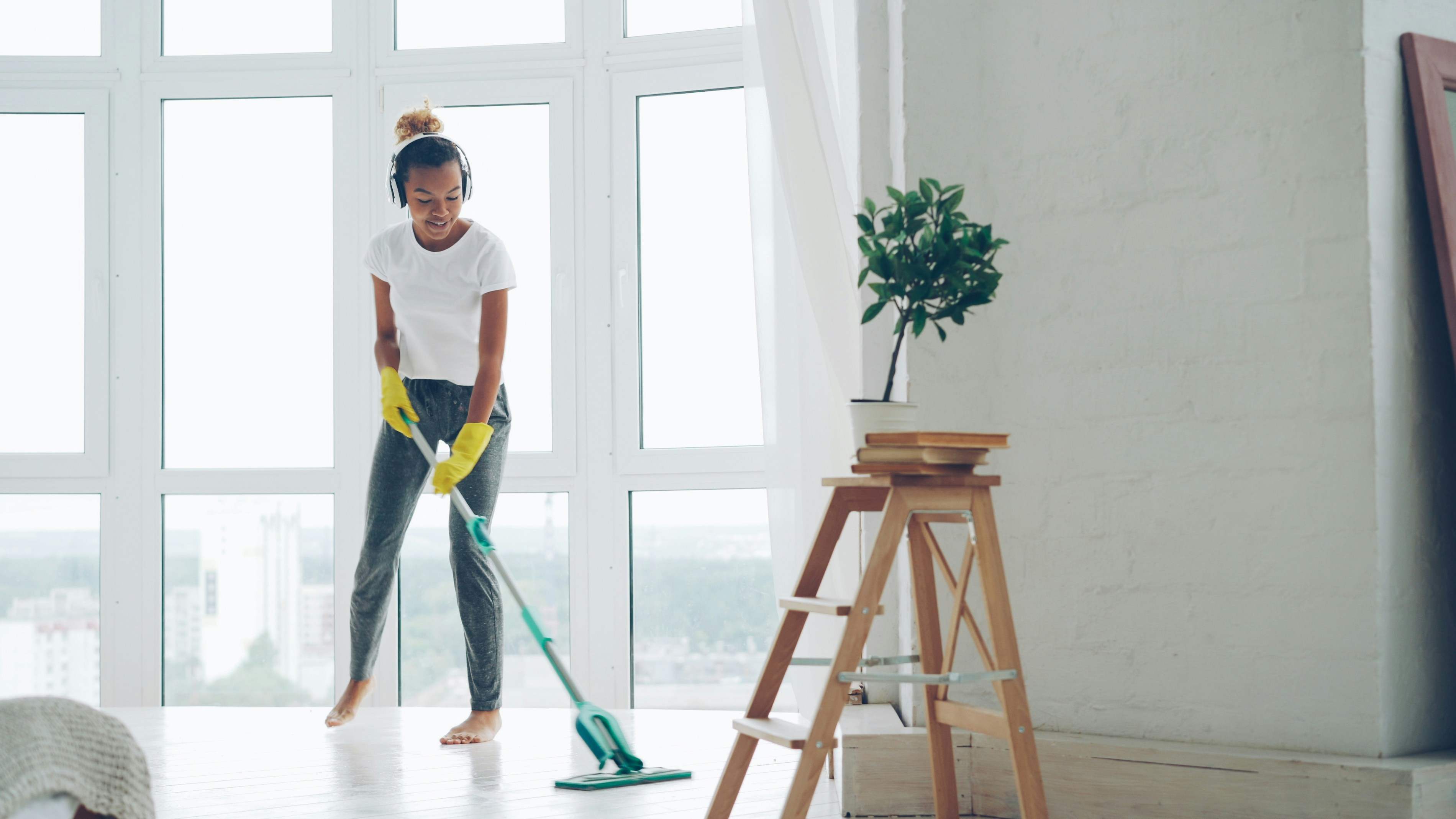 Residential cleaning — mopping a sunlit home