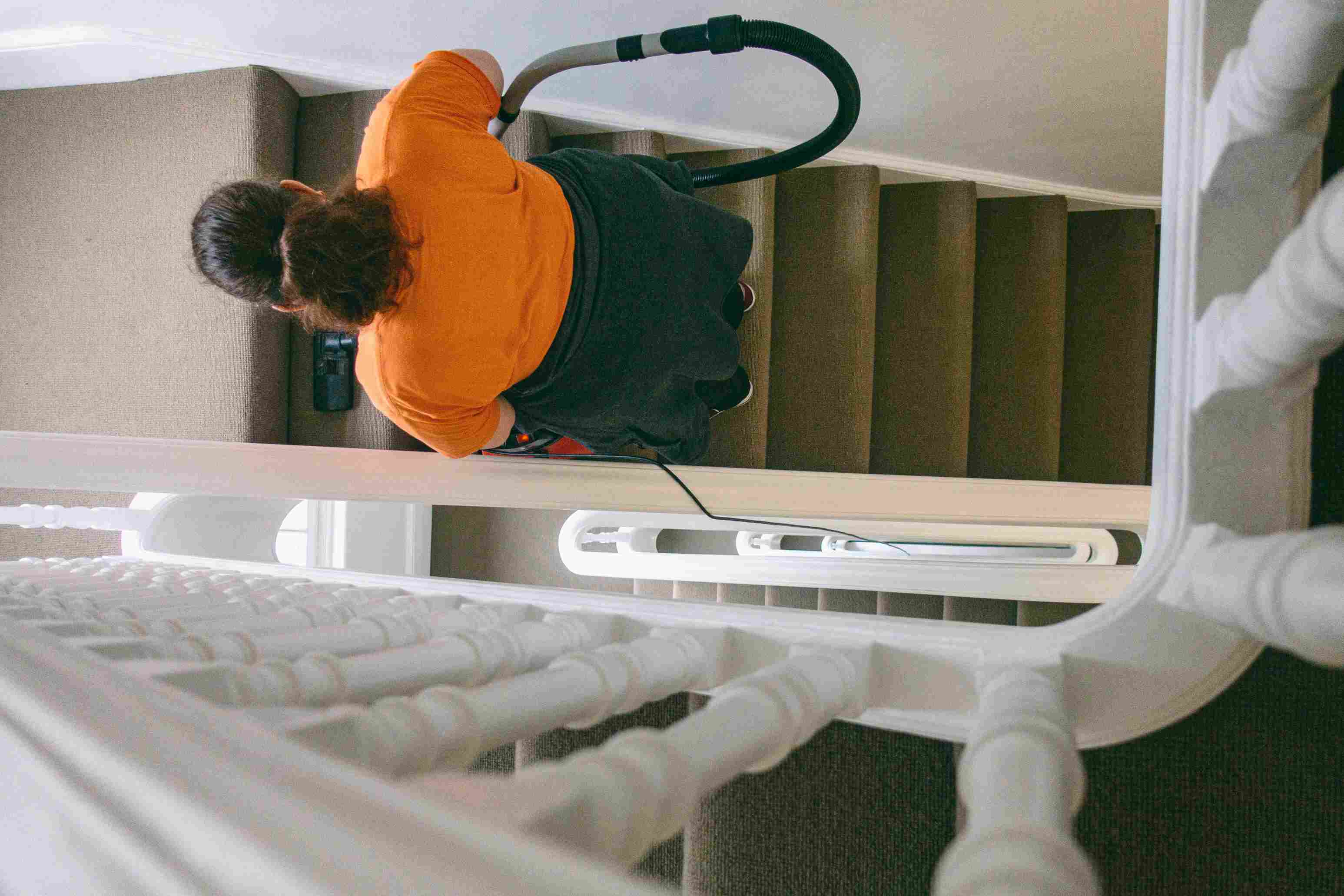 Deep cleaning — vacuuming carpeted stairs